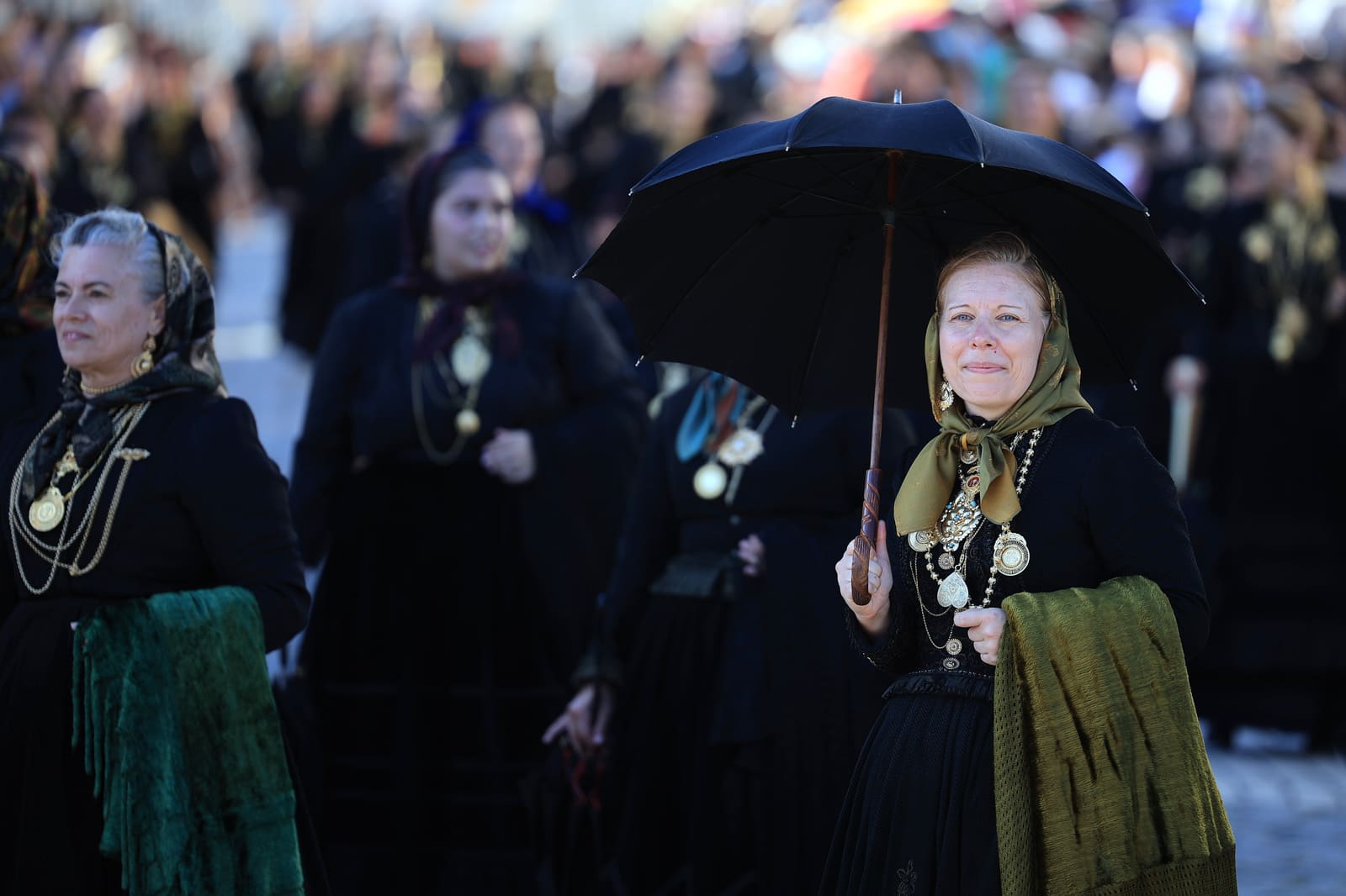 Portuguese women wearing traditional gold attached costumes take part in the annual parade of Our Lady Of Agony (Agonia) Pilgrimage in Viana do Castelo, Portugal, 16 August 2024. The pilgrimage dates back to the 18th century and is celebrated on the weekend after 15 August. The gold adorning the costumes has an overall value of several million euros. ESTELA SILVA/LUSA